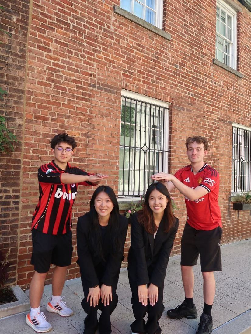 Workshop and Mentorship team members posing playfully together outside